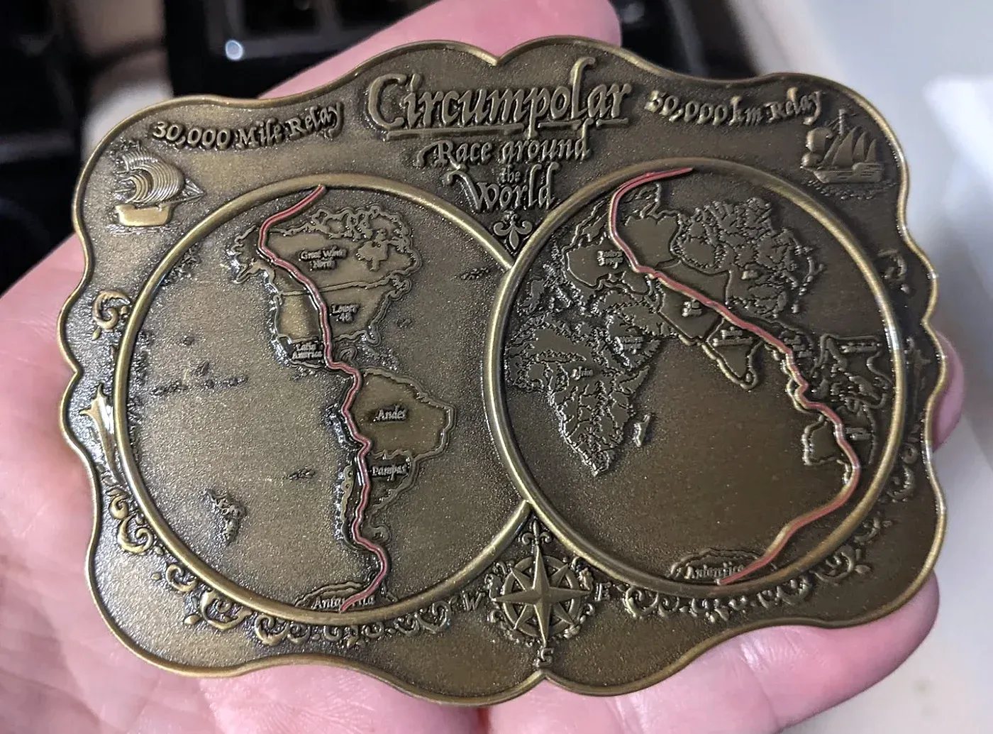 The CRAW finisher’s buckle: two hemispheres with the route traced in red