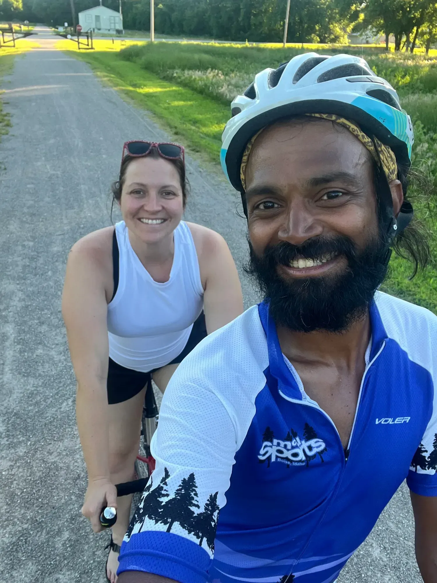 Selfie of Naresh on the tandem with a smiling rider in the back seat