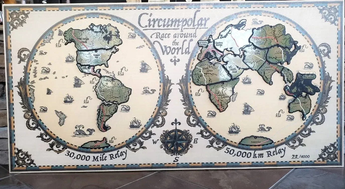 The CRAW display board: metal region medals fitted together into a world map, with the route traced across both hemispheres